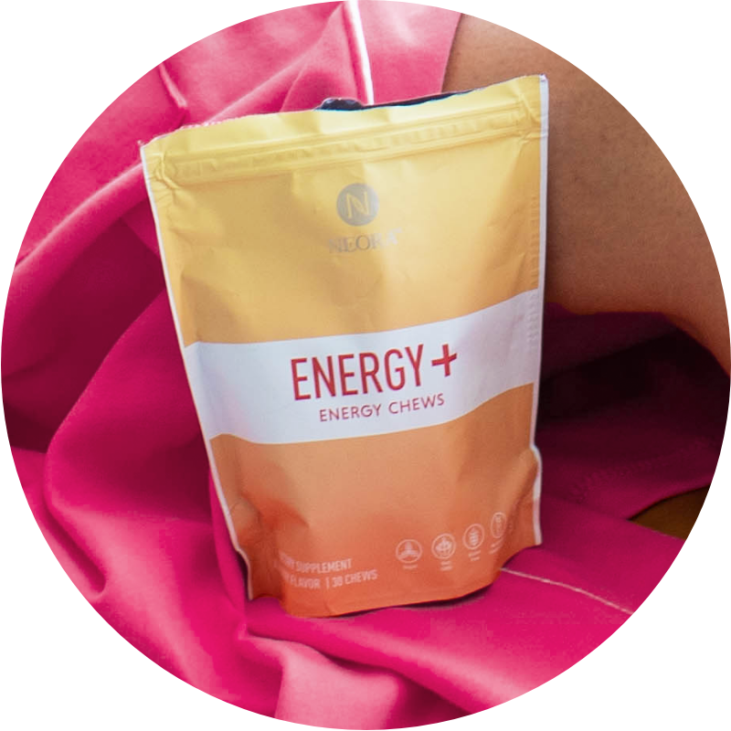 Image of Neora Energy+ Wellness Chews sitting on a pink blanket.